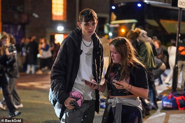 Two crestfallen youngsters stand on the street outside the O2 City Hall in Newcastle