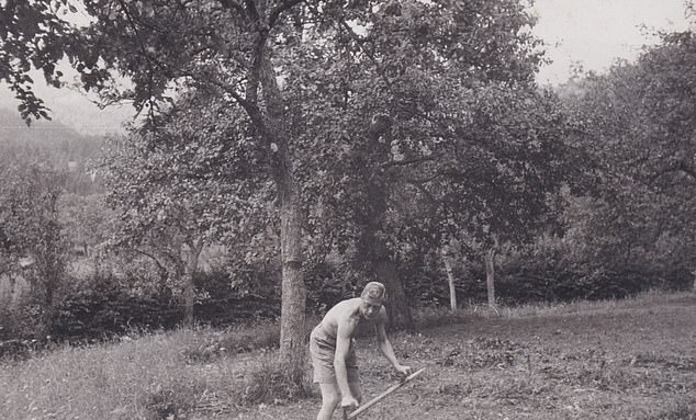 Another snap of Edward tending to a garden with a scythe, as he wears just a pair of shorts