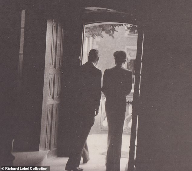 Edward and Wallis seen walking out of a door at the chateau on their wedding day