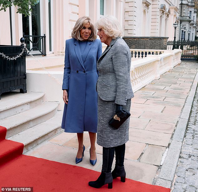 The French First Lady and the monarch converse on the red carpet before the event starts