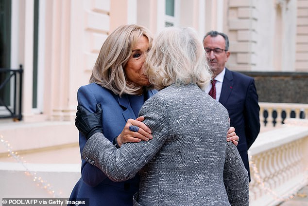 Brigitte Macron, 71, greets the Queen, 77, outside the French Ambassador's Residence in London