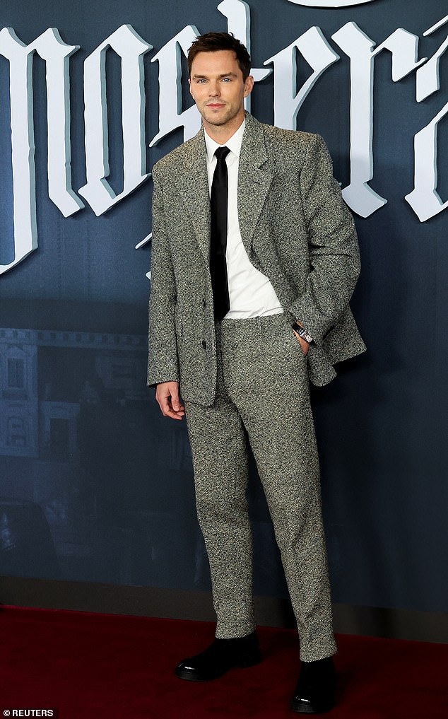 Nicholas Hoult, 34, looked stylish wearing a grey suit over a white shirt and black tie as he took to the red carpet