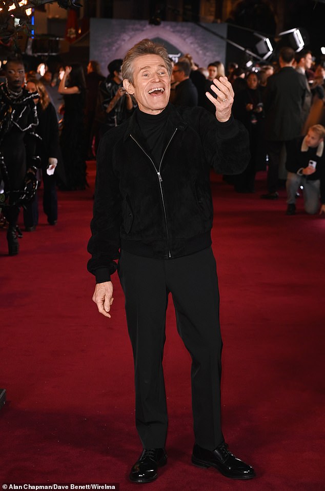 The actor, 69, beamed on the carpet as he waved to fans