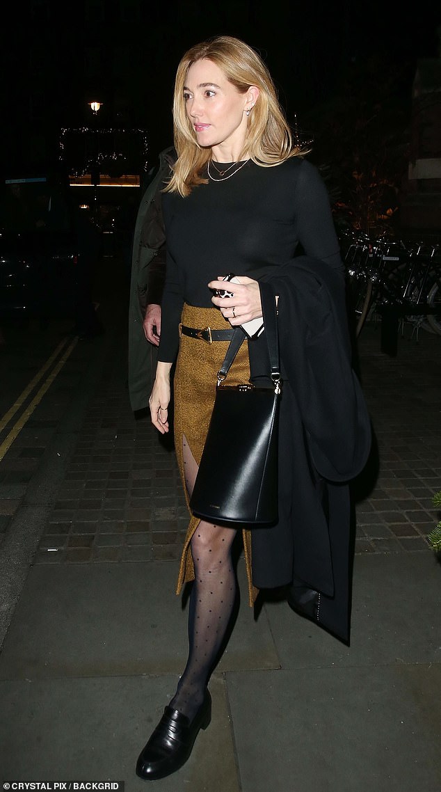 She completed the enemble with a pair of quirky tights and black leather handbag