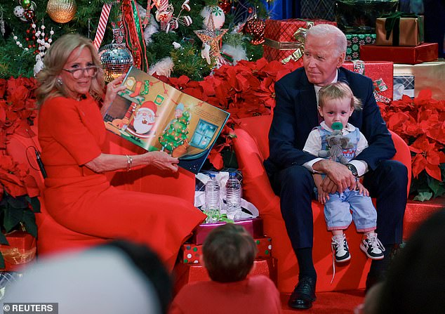 When a toddler approached him - making Dr. Biden crack up - the president motioned that it was OK to climb up on his chair. He held the young one for a few seconds, before the child ran off