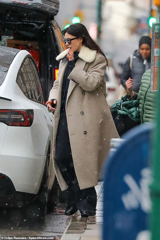 Anne layered her faux-fur trimmed outwear over a leather jacket and black trousers while shielding her eyes behind shades