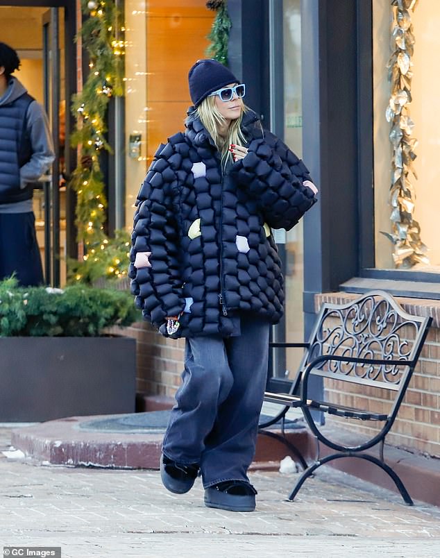 The America's Got Talent judge was bundled up for the outing in Colorado as she wore a quirky black and multi-coloured quilter oversized coat over a pair of baggy black jeans and chunky snow boots