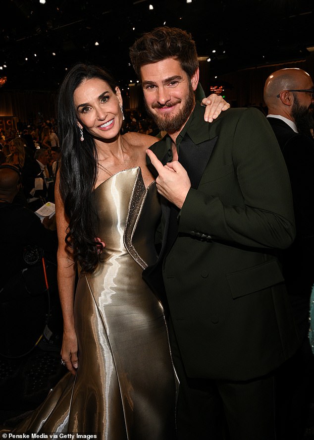 The inside of the ceremony was also filled with surprising celebrity pairings, including a beaming Demi Moore with Andrew Garfield