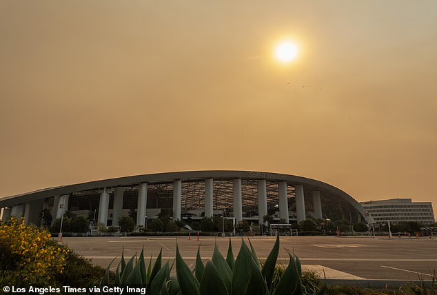 Smoke from the recent fires obscures the sun at SoFi Stadium in Inglewood