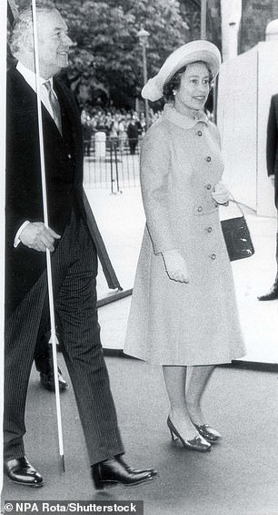 Queen Elizabeth wore an orange Hardy Amies coat   when she visited the Houses of Parliament in 1977