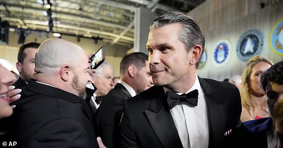 Defense Secretary nominee Pete Hegseth, center, attends the Commander in Chief Ball, Monday, Jan. 20, 2025, in Washington, after the 60th Presidential Inauguration. (AP Photo/Alex Brandon)