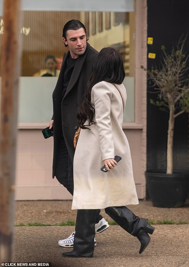 Fincham gazes at Ms Brocket today in Essex as the pair stroll through the street alongside one another