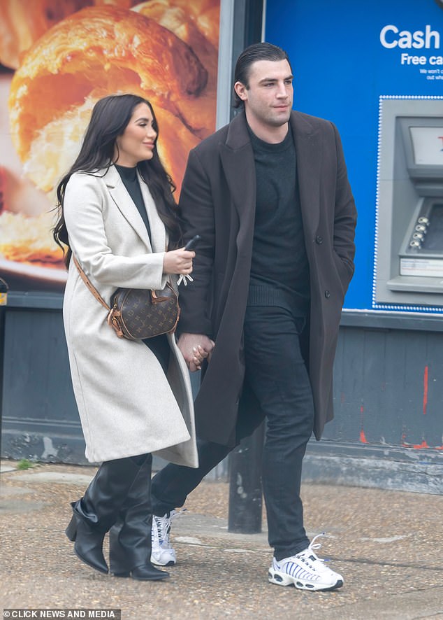 Fincham sported a dark brown coat, as well as black t-shirt and jeans alongside a pair of white trainers