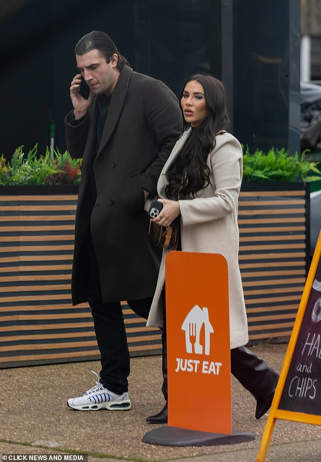 Fincham seen walking alongside his girlfriend whilst on a phone call following his sentencing earlier today