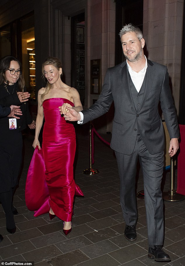 He was ever the gentleman as he helped Renee navigate the sidewalk in her heels