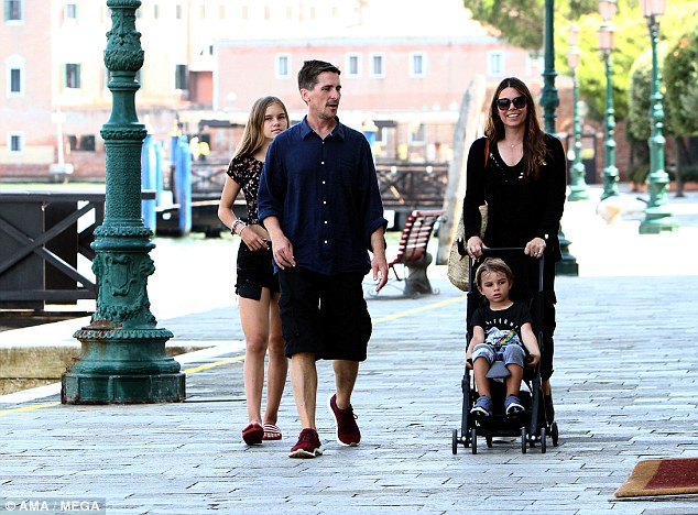 Family fun: Joining by his wife Sibi and children Emmeline, 13, and Joseph, 3, the acclaimed actor looked incredible in a buttoned down shirt and black shorts