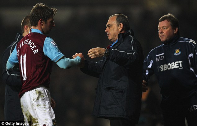 Long tome coming: Even Grant (centre) can afford a smile as he congratulates Hitzlsperger on his contribution