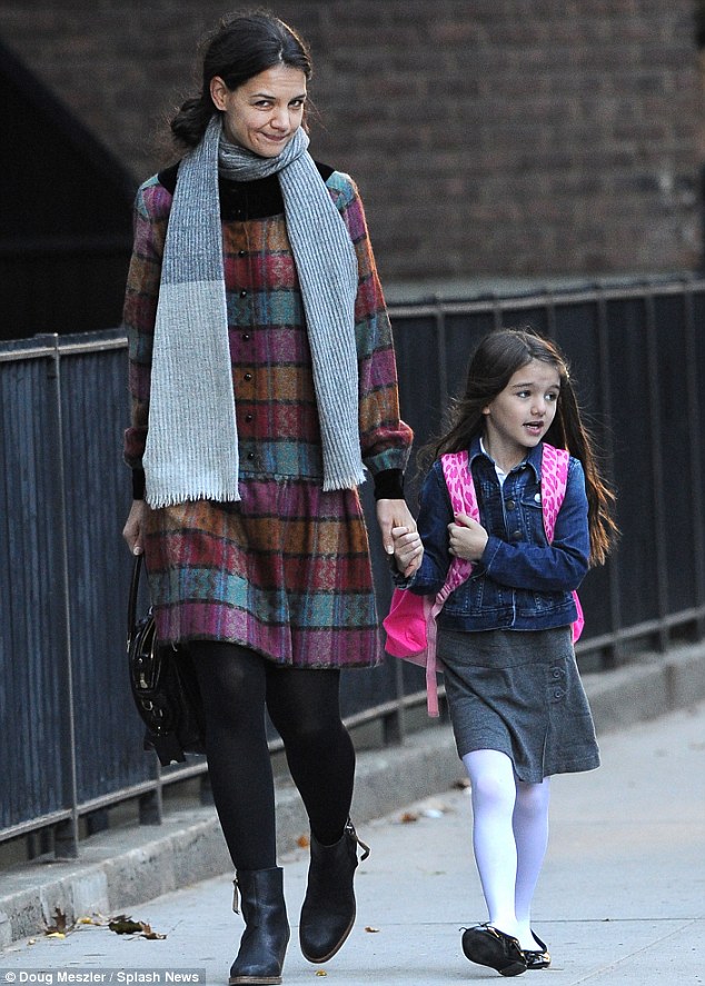 Uniform: Suri dressed in a grey pinafore and white tights to head to class