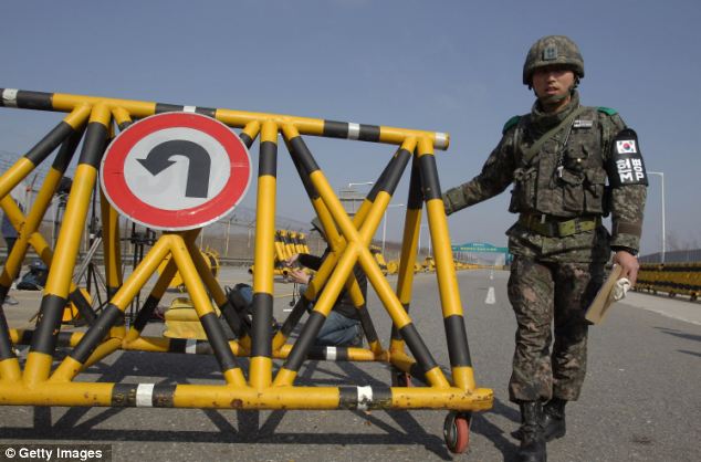 A South Korean soldier sets up a barricade on the road connecting South and North Korea at the Unification Bridge