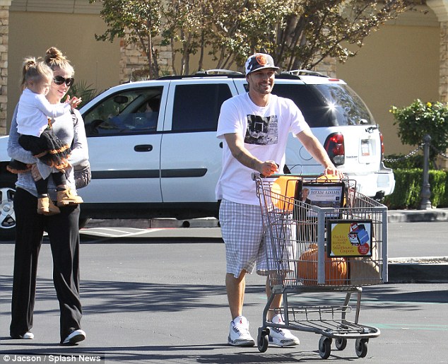 All shopped out: Jordan got a lift to the car from her mum as Kevin pushed the trolley of treats