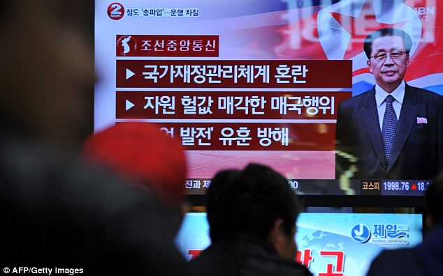 News spreads: South Korean people watch a news program about the alleged dismissal of Jang Song-Thaek at a railway station in Seoul