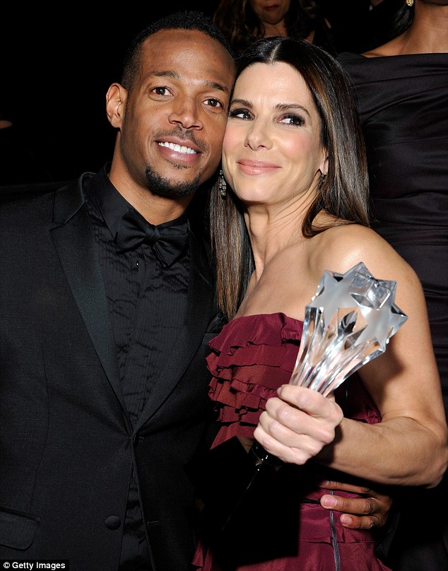 'I just kissed Marlon Wayans, alright!': The 49-year-old cosied up to the award's presenter backstage after revealing her excitement at getting to kiss him