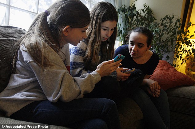 Studying in style: Kate McClintock, 12, left, Kate Green, 13, and Lilly Bond, 13, are seventh-graders at Haven Middle School in Evanston, which has been at the center of a controversy over its dress code