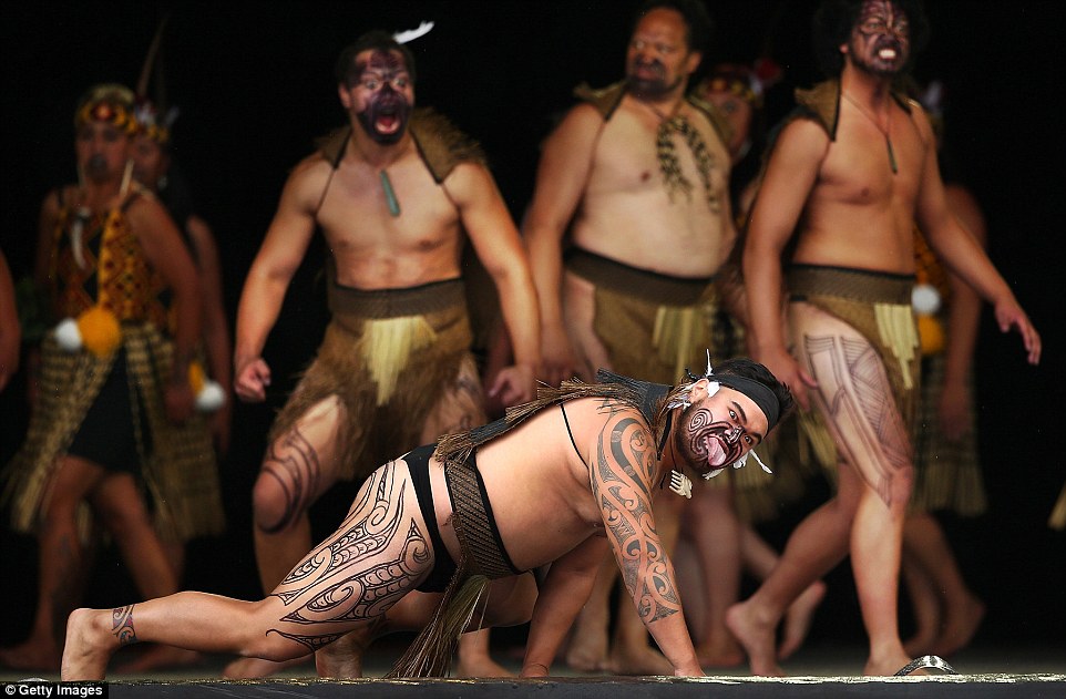 Members of Tu Te Maungaroa from Wellington showcase elaborate face and body tattoos on their arms, legs and cheeks