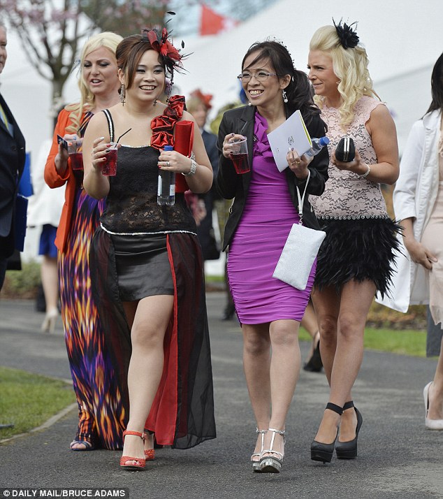 Strange fashion choices at Ladie's Day include furry skirts and dresses which are short in the front and long in the back