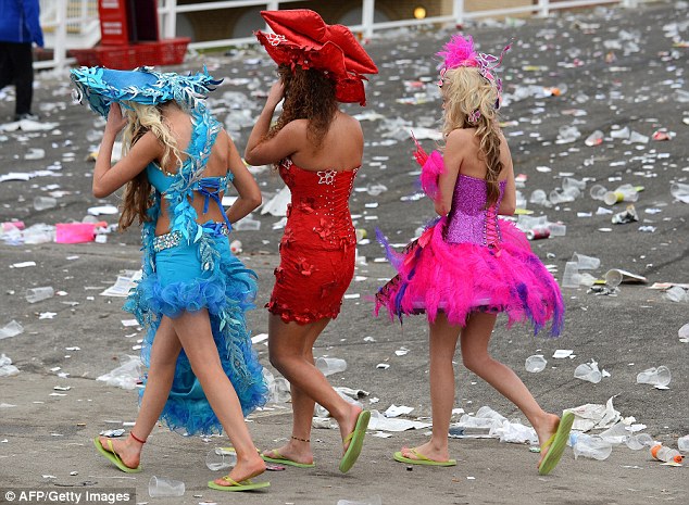 Garishly-dressed racegoers leave the course in flip-flops at the end of Ladies' Day last year