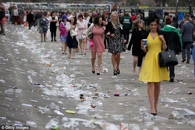 Rubbish litters the ground as racegoers make their way home at the end of Ladies Day at the Aintree Grand National Festival meeting last year