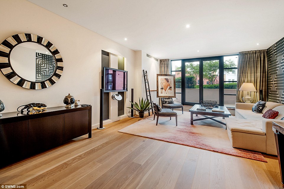 The luxury living room of the flat on the second floor of the Trevor Square block in Knightsbridge, formerly a Harrods depository, which features this large reception room with doors into the balcony