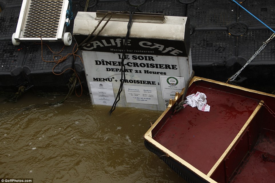 Driftwood, signs and furniture have been seen floating down the River Seine as Paris entered yet another day of flooding