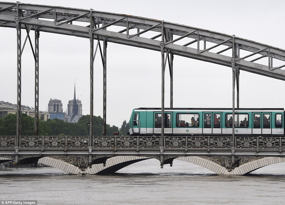 A Paris subway train passes on the Viaduc d'Austerlitz bridge on Saturday above the Seine river