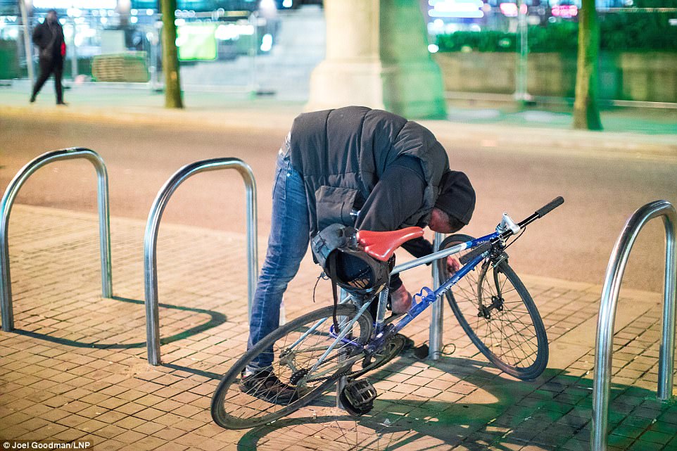 A man stands bent over a bike rack, having been left almost immobile after taking the highly addictive drug