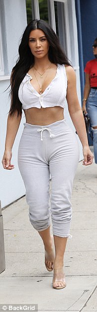 In crop tops that sit just below her chest (like the black bandeau she paired with Yeezy sweats in August) she shows off her toned tummy and prevents the baggy bottoms from swallowing up her fabulous figure