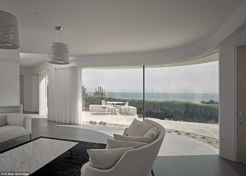 Breathtaking: This interior wouldn't look out of place in the Hollywood Hills but is in fact perched atop the White Cliffs of Dover. Folding walls and screens that open the space and make use of the stunning views from the large living area, pictured