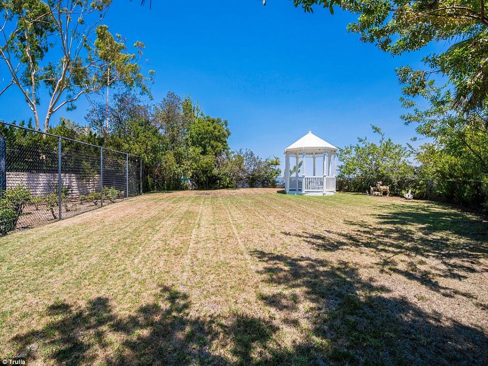 Picturesque: A white gazebo sat at the end of the backyard