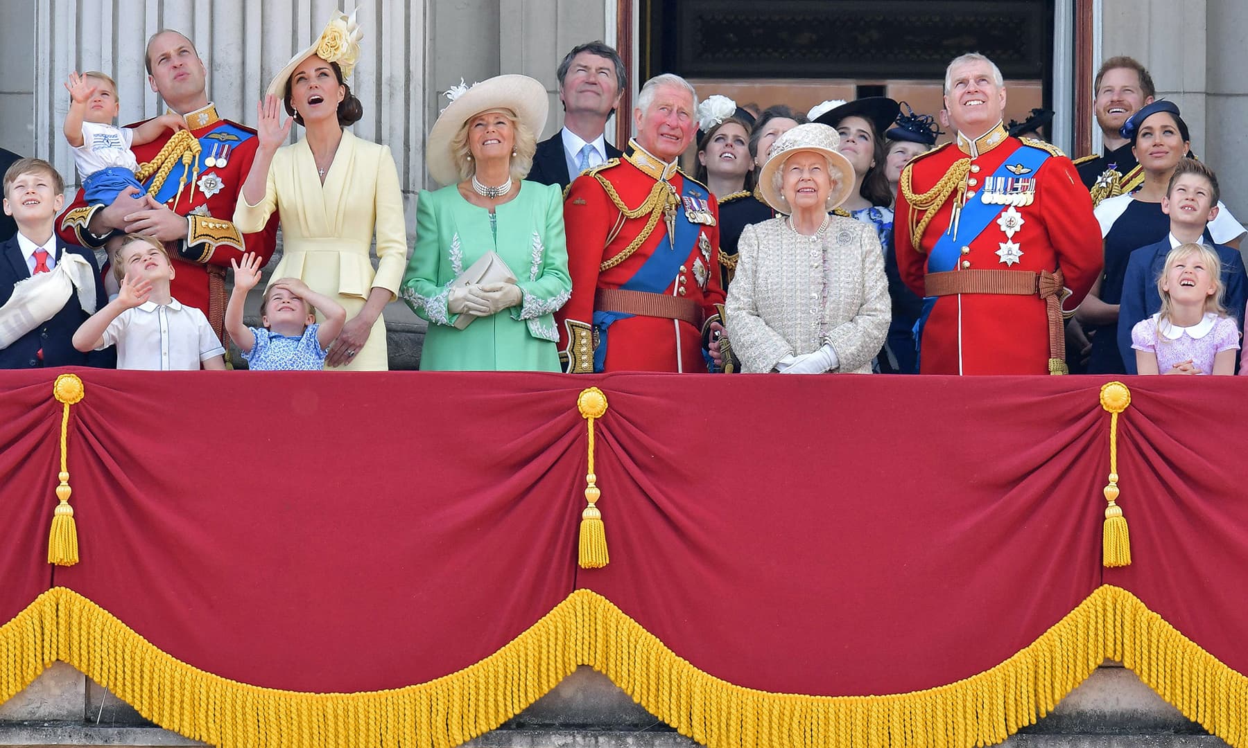 Britain's Prince William, Duke of Cambridge holding Prince Louis, Prince George, Princess Charlotte, Britain's Catherine, Duchess of Cambridge, Britain's Camilla, Duchess of Cornwall, Vice Admiral Timothy Laurence, Britain's Prince Charles, Prince of Wales, Britain's Princess Beatrice of York, Britain's Princess Anne, Princess Royal, Britain's Queen Elizabeth II, Britain's Princess Eugenie of York, Britain's Lady Louise Windsor, Britain's Prince Andrew, Duke of York, Britain's Prince Harry, Duke of Sussex, Britain's Meghan, Duchess of Sussex, James, Viscount Severn and Isla Phillips stand with other members of the Royal Family on the balcony of Buckingham Palace to watch a fly-past of aircraft by the Royal Air Force. — AFP