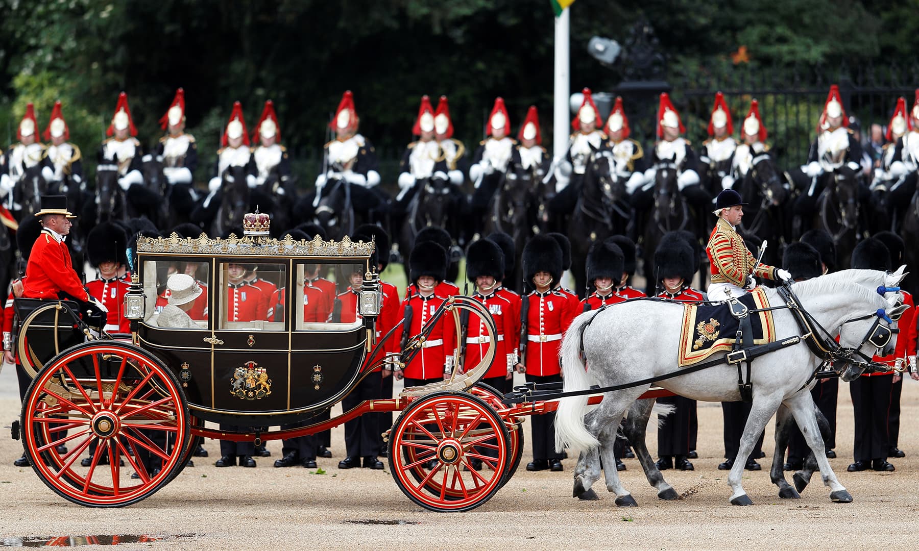 Britain's Queen Elizabeth pictured in her horse-drawn carriage as she participates in the Trooping the Colour parade in central London, Britain. — AFP