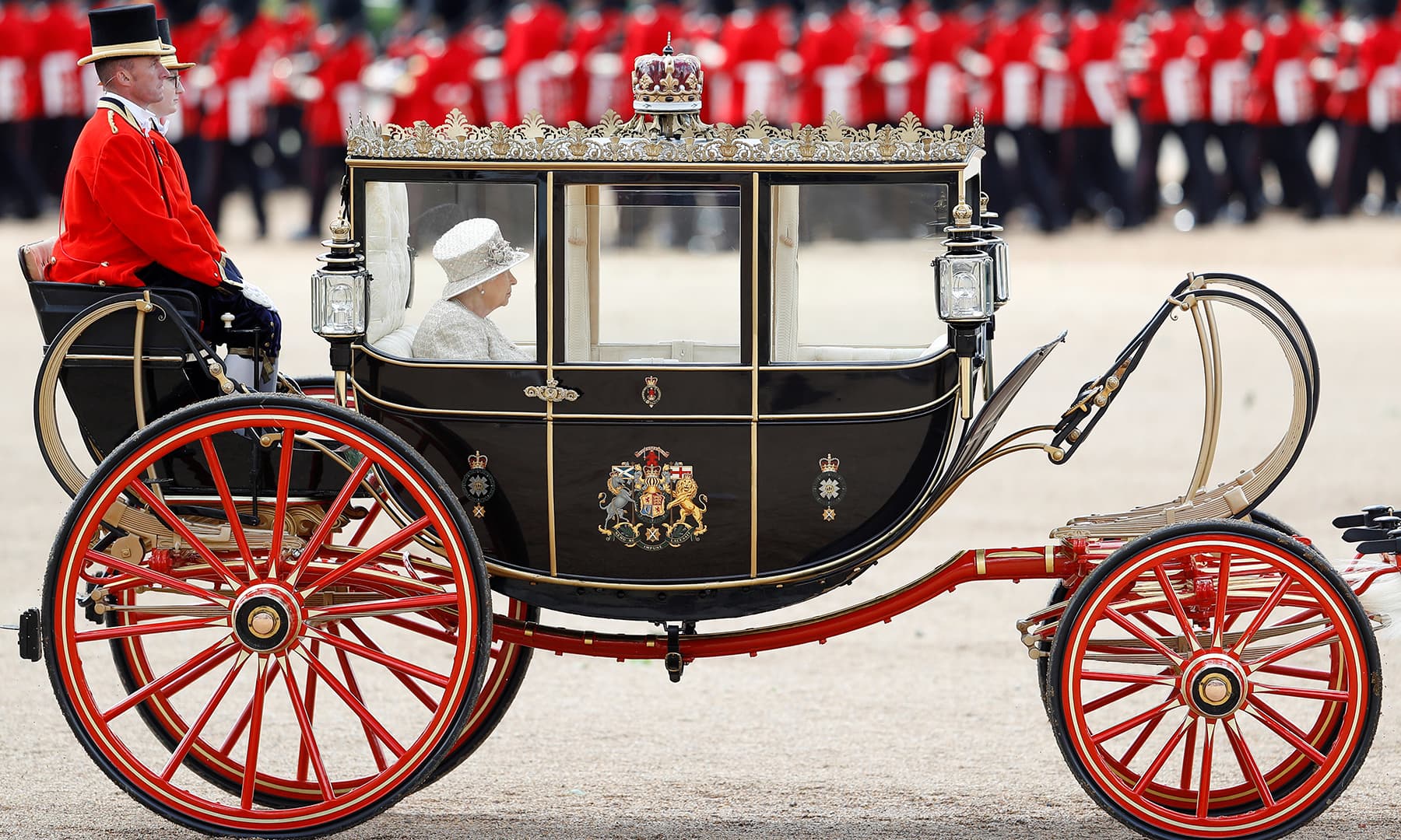 A full view and close up of the Queen's horse-drawn carriage. —Reuters