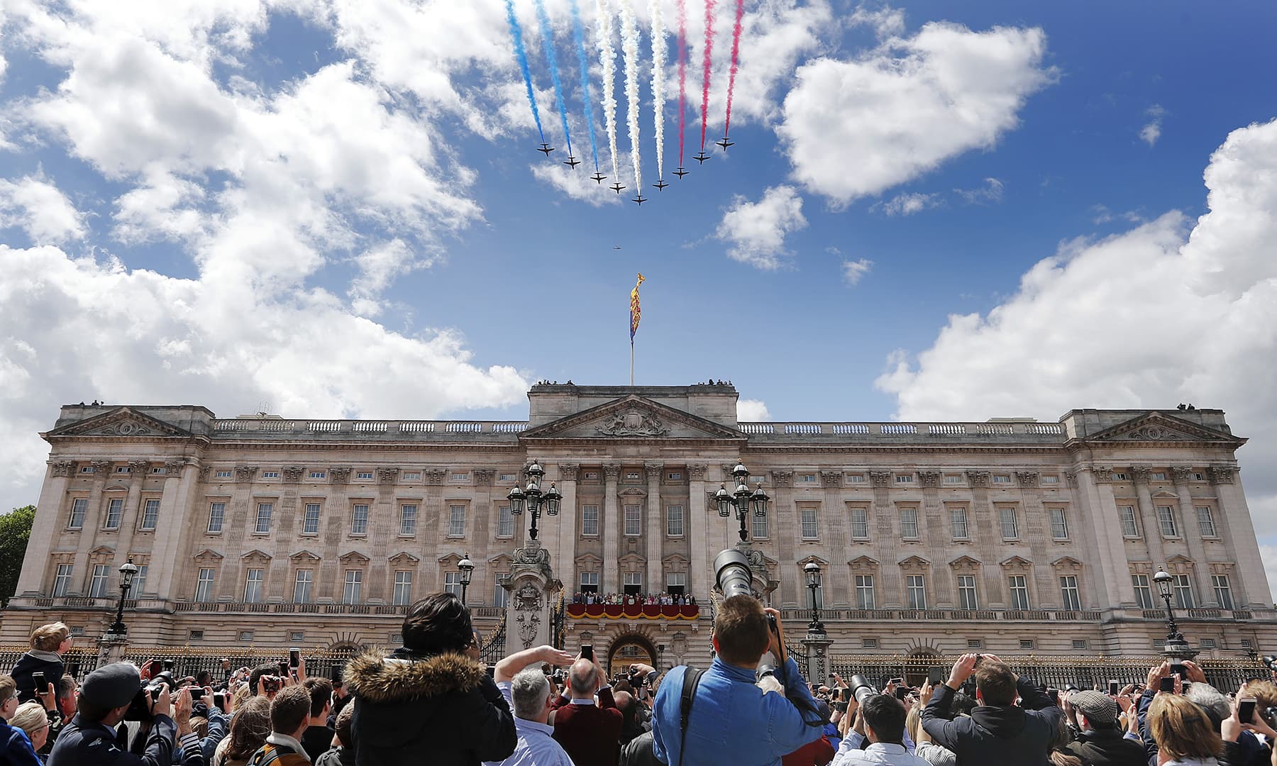 Airplanes of the Red Arrows fly over Buckingham Palace. — AP