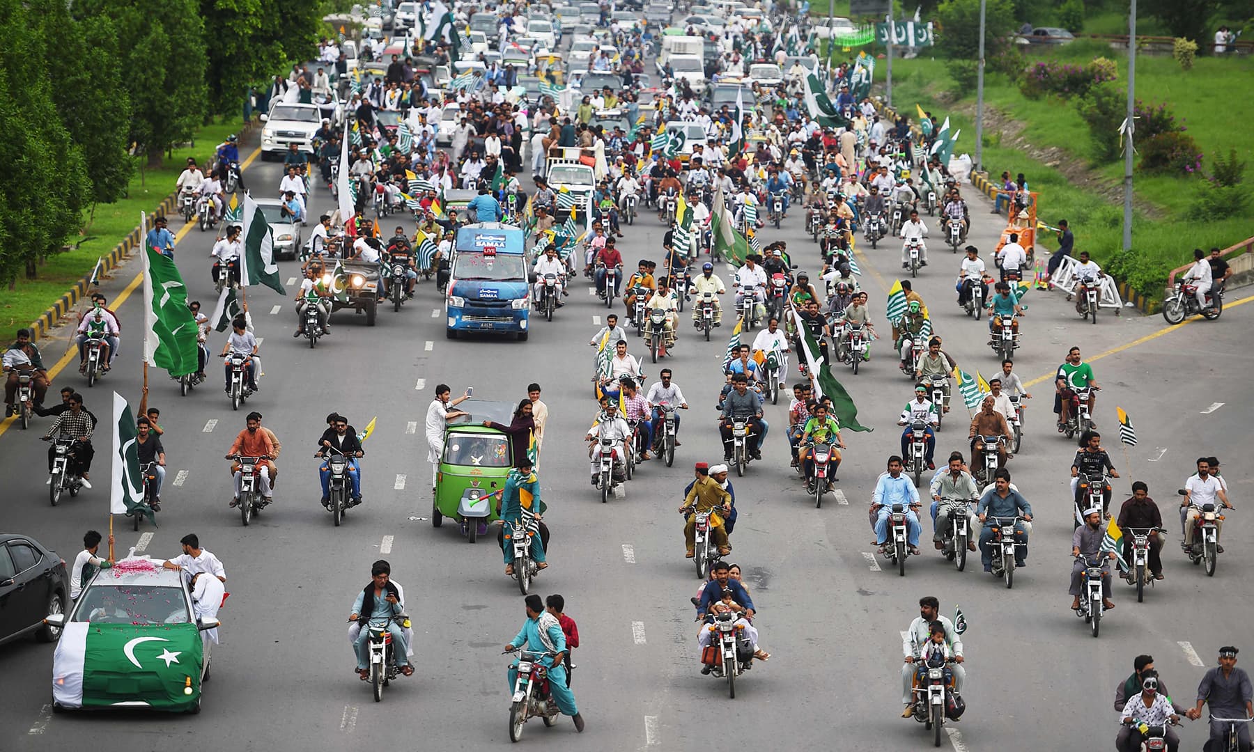 People take part in Independence Day celebrations in Islamabad on Wednesday. — AFP