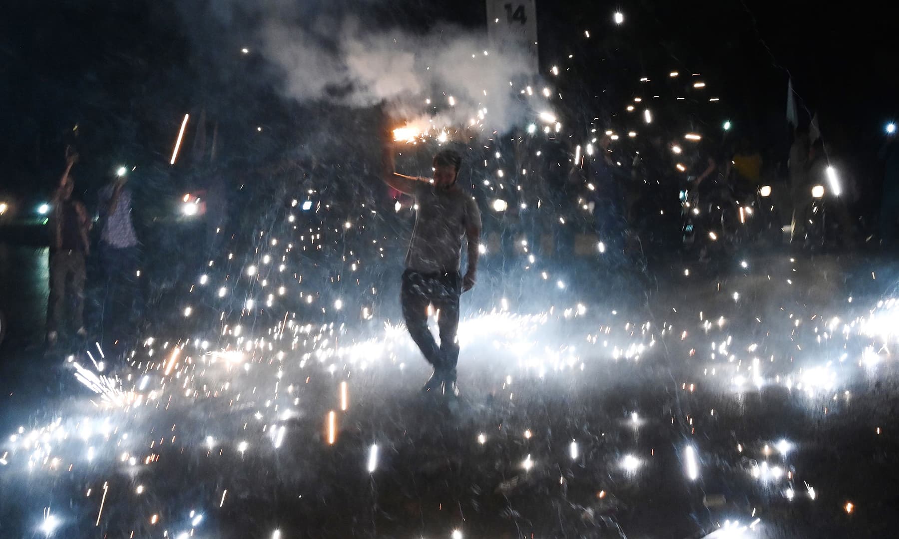 People take to the streets during Independence Day celebrations in Islamabad on Wednesday. — AFP