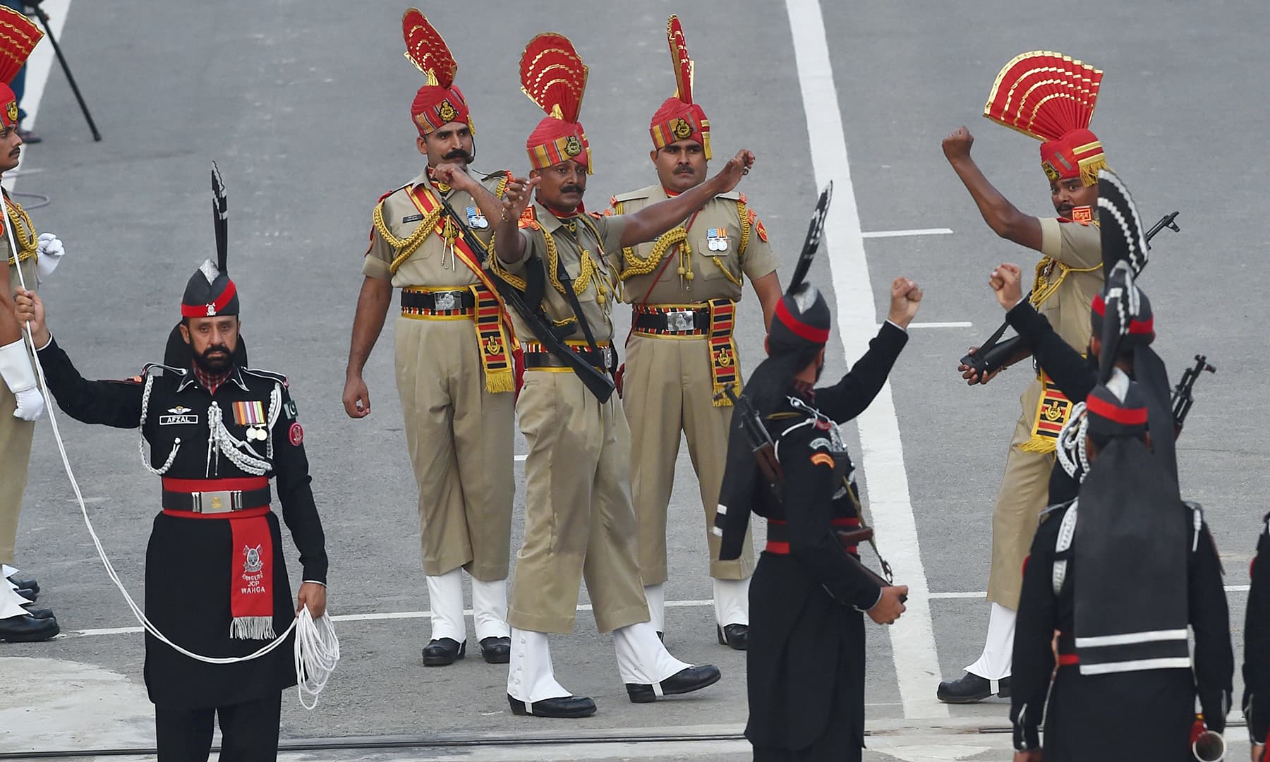 Pakistan Rangers (wearing black) and Indian Border Security Force personnel (wearing brown) take part in daily beating of the retreat ceremony at the Wagah border on Wednesday. — AFP