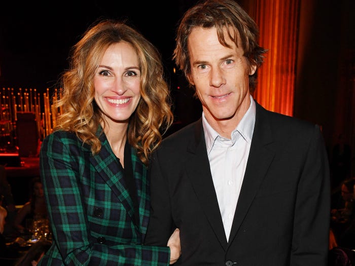 Julia Roberts wears a green plaid suit and poses next to husband Daniel Moder.