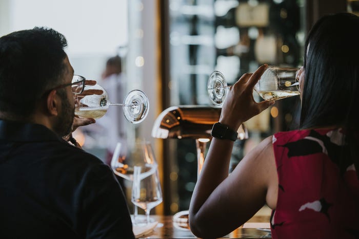 People drinking from universal wine glasses