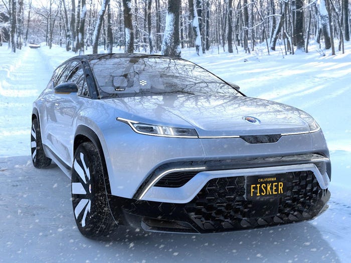 A silver Fisker Ocean in the snow with a license plate that says "Fisker."