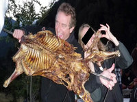 RFK Jr Dog Photo depicting him and a woman eating a BBQ animal carcass.