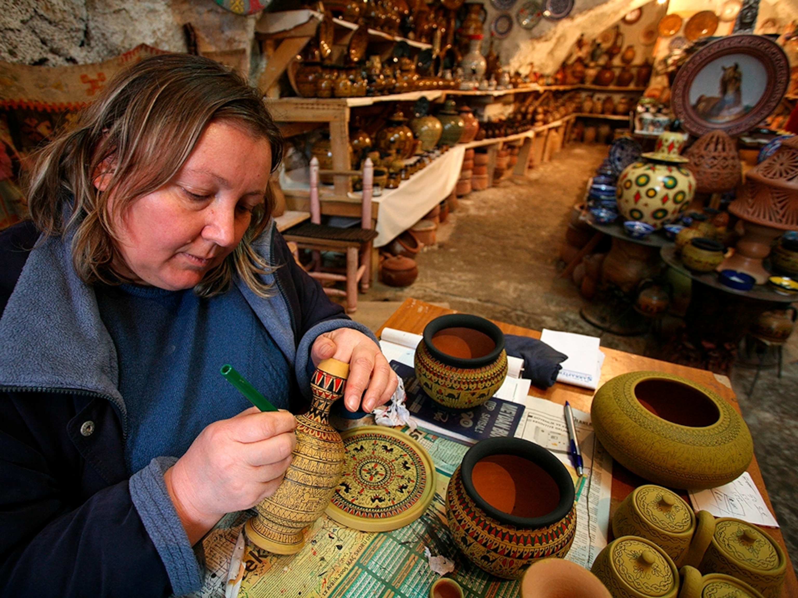 a woman painting pottery near Cappadocia, Turkey